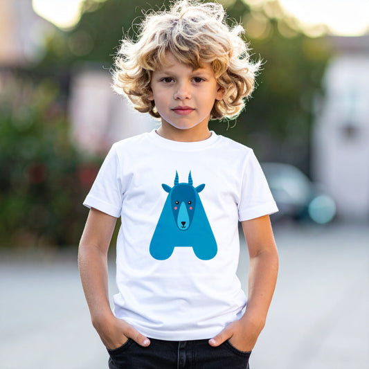 Blond boy wearing a white cotton t shirt with the letter A in the shape of an antelope illustration, hands in pocket