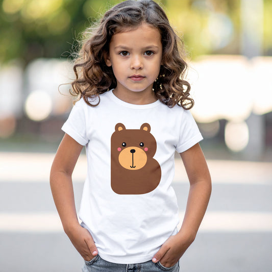 Girl wearing a white cotton t shirt with the letter B in the shape of a bear illustration, hands in pocket