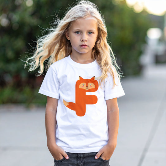 Girl wearing a white cotton t shirt with the letter F in the shape of a fox illustration, hands in pocket