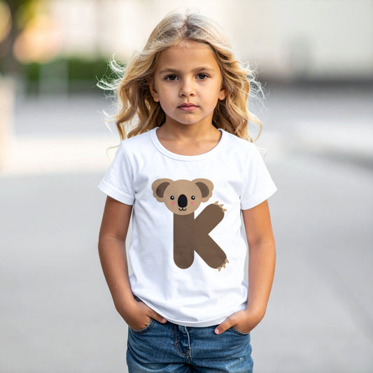 Girl wearing a white cotton t shirt with the letter K in the shape of an koala illustration, hands in pocket