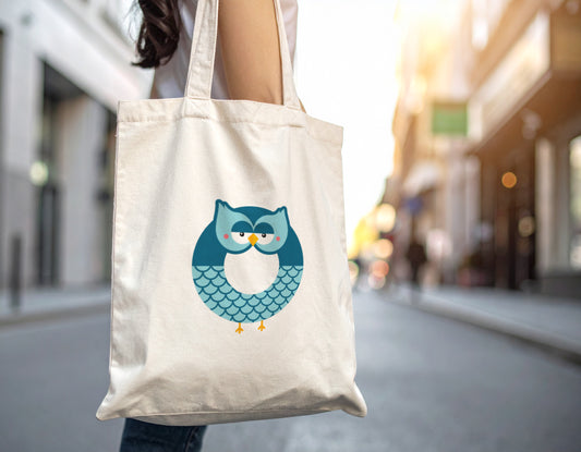 A woman carrying an oyster tote bag with the letter O in the shape of an owl illustration on a blurred city street background.