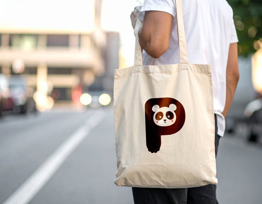 A man carrying an oyster tote bag with the letter P in the shape of an panda illustration on a blurred city street background.