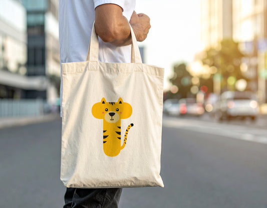 A man carrying an oyster tote bag with the letter “T” in the shape of a tiger illustration on a blurred city street background.