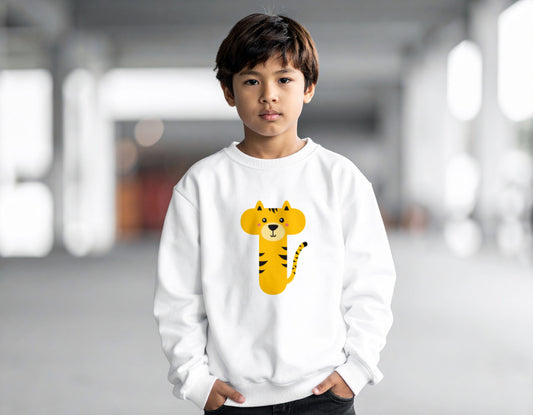 A teenage boy wearing a white crewneck sweatshirt with the letter T in the shape of a tiger illustration, standing in a blurry indoor setting.